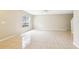 Spacious living room with tile flooring, a large window, and neutral-colored walls at 7303 E Bank Dr, Tampa, FL 33617