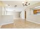 Open-concept living room with neutral walls and tile flooring at 7303 E Bank Dr, Tampa, FL 33617