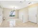 Spacious living area with tile flooring, a chandelier, and a view of the front entrance at 7303 E Bank Dr, Tampa, FL 33617