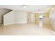 Bright, open living space with tile flooring, a ceiling fan, and a partial view of the kitchen at 7303 E Bank Dr, Tampa, FL 33617