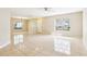 Spacious living room with tile floors, large windows, and neutral paint, perfect for entertaining at 7303 E Bank Dr, Tampa, FL 33617