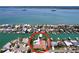 Waterfront home with a private pool and a boat dock on a sunny day at 773 Snug Is, Clearwater Beach, FL 33767