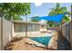 Backyard featuring shade sails, offering a pleasant and shaded area for outdoor activities at 8031 7Th N St, St Petersburg, FL 33702