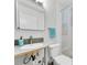 Clean bathroom featuring a sink, toilet, and a shower with patterned shower curtain at 8031 7Th N St, St Petersburg, FL 33702