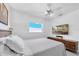 Simple bedroom featuring a ceiling fan, flat screen television, and white walls at 8031 7Th N St, St Petersburg, FL 33702