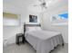 Well lit bedroom featuring a ceiling fan and two large windows at 8031 7Th N St, St Petersburg, FL 33702