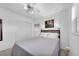 Clean, bright bedroom featuring a ceiling fan, closet, and light gray walls at 8031 7Th N St, St Petersburg, FL 33702