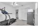 Large bonus room with a treadmill and stainless steel refrigerator at 8031 7Th N St, St Petersburg, FL 33702