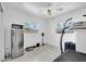Bright bonus room with stainless steel refrigerator and a treadmill at 8031 7Th N St, St Petersburg, FL 33702