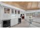Bright dining area with a custom bar, built-in wine coolers, and views of the backyard at 8031 7Th N St, St Petersburg, FL 33702