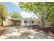 Lovely home showcasing the front yard, carport, and mature trees providing shade at 8031 7Th N St, St Petersburg, FL 33702