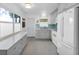 Spacious kitchen with white appliances, gray cabinets, and ample counter space at 8031 7Th N St, St Petersburg, FL 33702