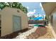 Backyard featuring storage shed adjacent to the shade sails, offering practical outdoor space at 8031 7Th N St, St Petersburg, FL 33702
