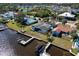Waterfront property featuring a screened-in pool, private dock, and lush surroundings with multiple boat docks at 828 Bayshore Dr, Tarpon Springs, FL 34689