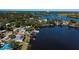 Panoramic view highlighting waterfront homes, their docks, and surrounding greenery, showcasing serene coastal living at 828 Bayshore Dr, Tarpon Springs, FL 34689