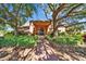 Community building framed by mature trees and landscaping, creating a serene atmosphere at 8528 Fantasia Park Way, Riverview, FL 33578