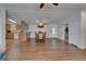 Open-concept dining area featuring wood floors, dining table and chairs, and kitchen access at 8528 Fantasia Park Way, Riverview, FL 33578
