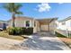 Inviting single-story home featuring a covered parking area and lush landscaping, perfect for relaxed living at 8528 Fantasia Park Way, Riverview, FL 33578