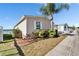 Charming home featuring lush landscaping, a palm tree, and a waterfront view at 8528 Fantasia Park Way, Riverview, FL 33578