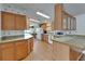Well-lit kitchen with wood cabinets, modern appliances, and adjacent dining area at 8528 Fantasia Park Way, Riverview, FL 33578