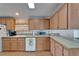 Traditional kitchen featuring wood cabinets, laminate countertops and modern appliances at 8528 Fantasia Park Way, Riverview, FL 33578