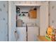 Compact laundry closet with a washer, dryer and shelving units for storage at 8528 Fantasia Park Way, Riverview, FL 33578