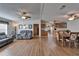Spacious living and dining area showcasing wood floors, ceiling fans, and open layout at 8528 Fantasia Park Way, Riverview, FL 33578