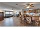 Open-concept living and dining area with hardwood floors, ceiling fans and lots of seating at 8528 Fantasia Park Way, Riverview, FL 33578