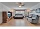Inviting living room with hardwood floors, ceiling fan, and comfortable gray reclining sofas at 8528 Fantasia Park Way, Riverview, FL 33578