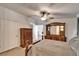 Bright main bedroom features a bed, dresser, and access to the bathroom at 8528 Fantasia Park Way, Riverview, FL 33578