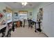 Bright room with natural light, ceiling fan, and two sewing tables at 8528 Fantasia Park Way, Riverview, FL 33578