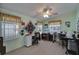 Bright room with natural light, ceiling fan, and two sewing tables at 8528 Fantasia Park Way, Riverview, FL 33578