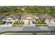 Overhead view of three homes on a paved street, showing well-manicured lawns and mature landscaping at 8975 Southern Charm Cir, Brooksville, FL 34613