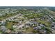 This aerial shot features a community lined with mature trees, landscaped yards and well-maintained homes at 8975 Southern Charm Cir, Brooksville, FL 34613
