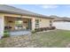 Backyard with covered patio and well-maintained landscaping at 8975 Southern Charm Cir, Brooksville, FL 34613