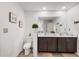 Bright bathroom featuring a double vanity, toilet, and decorative wall art at 8975 Southern Charm Cir, Brooksville, FL 34613
