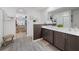 Bathroom with double sinks, closet, and modern fixtures at 8975 Southern Charm Cir, Brooksville, FL 34613