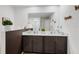 Modern bathroom featuring a double vanity with white countertops and dark wood cabinets at 8975 Southern Charm Cir, Brooksville, FL 34613