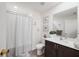 Bathroom featuring a shower with a curtain and vanity with storage at 8975 Southern Charm Cir, Brooksville, FL 34613