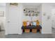 Cozy mudroom area with decorative seating and shelving providing useful storage at 8975 Southern Charm Cir, Brooksville, FL 34613