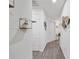 Hallway with a decorative shelf and doorway signs pointing to various rooms at 8975 Southern Charm Cir, Brooksville, FL 34613