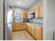 Bright kitchen featuring light wood cabinets, stainless steel refrigerator, and a breakfast nook at 8975 Southern Charm Cir, Brooksville, FL 34613