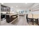 Spacious kitchen with island seating that flows into the living and dining areas at 8975 Southern Charm Cir, Brooksville, FL 34613