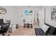 Relaxing living room area with desk, sofa, and view into the home's hallway at 8975 Southern Charm Cir, Brooksville, FL 34613