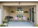 Cozy patio area with grill and seating with a view of the backyard at 8975 Southern Charm Cir, Brooksville, FL 34613
