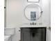 Bathroom with a modern vanity, a circular mirror, black hardware, and a toilet at 9481 Highland Oak Dr # 514, Tampa, FL 33647