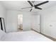 Clean bedroom with white bedding, a ceiling fan, and multiple closets for ample storage space at 9481 Highland Oak Dr # 514, Tampa, FL 33647