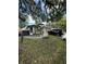 Beautiful home with a well-manicured lawn, decorative rock garden, and a circular driveway at 2917 W Fern St, Tampa, FL 33612