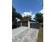 Charming single-story home featuring neutral paint, a brown garage door, and a stylish driveway at 2917 W Fern St, Tampa, FL 33612