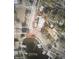 Aerial view of a property, outlined in red, with a pool, situated on a street corner near a lake at 101 Pampas Ave, Tarpon Springs, FL 34689